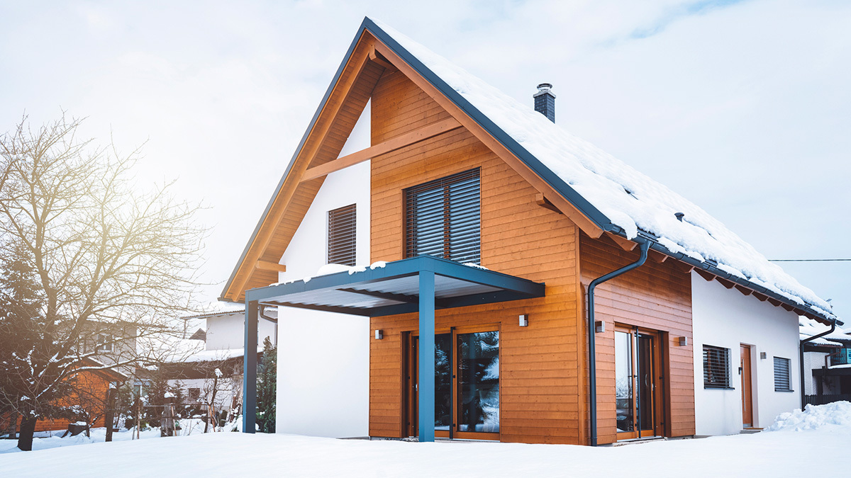 Barndominium house with snow.